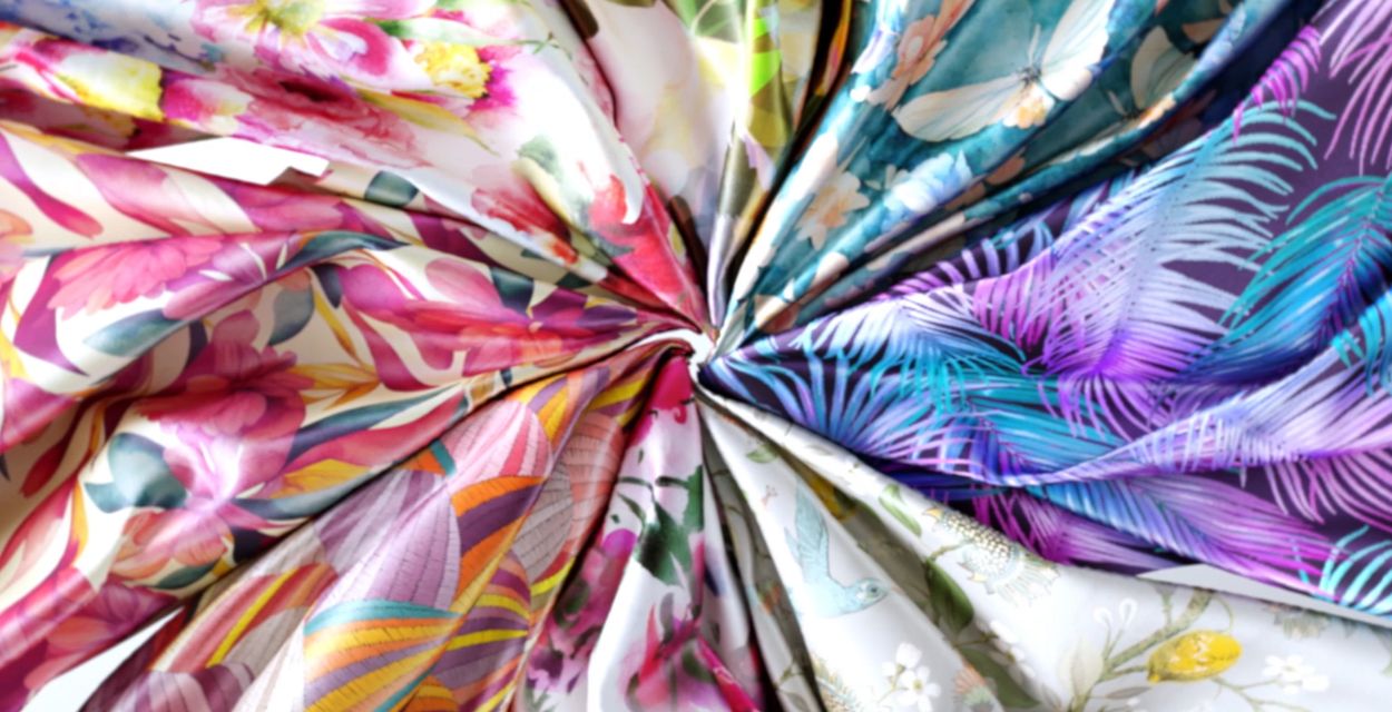 Water-based pigment inks and pre- and post-treatment solutions developed in-house enable printing on a wide range of fabrics—including cotton, silk, polyester, nylon, and blends—without the need to change inks.