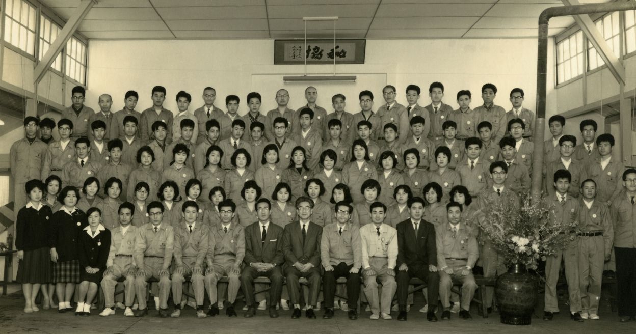 Commemorative photo taken on April 1, 1961, the company’s second anniversary, before management was confronted with collective bargaining