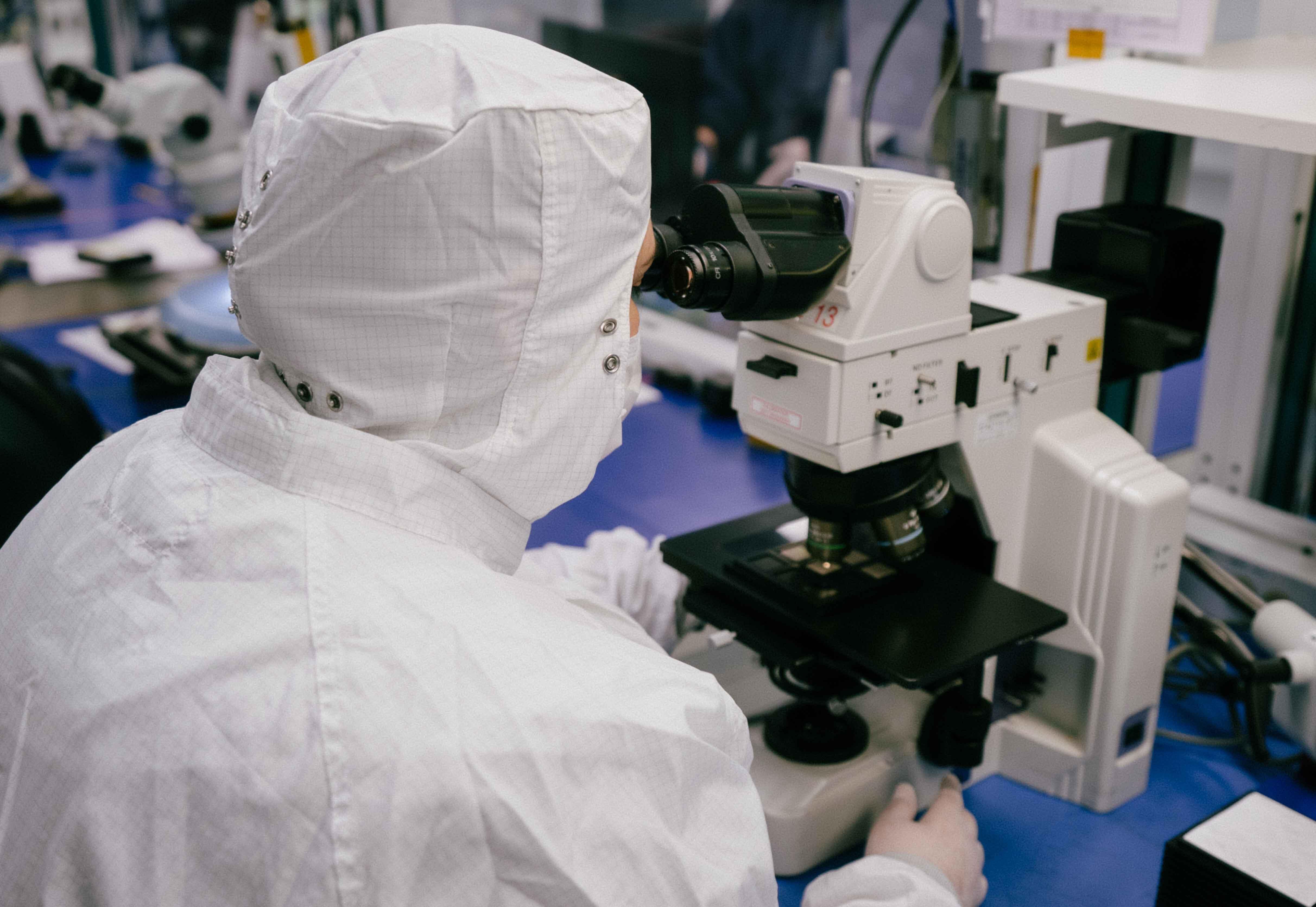 Jessica looking into a microscope