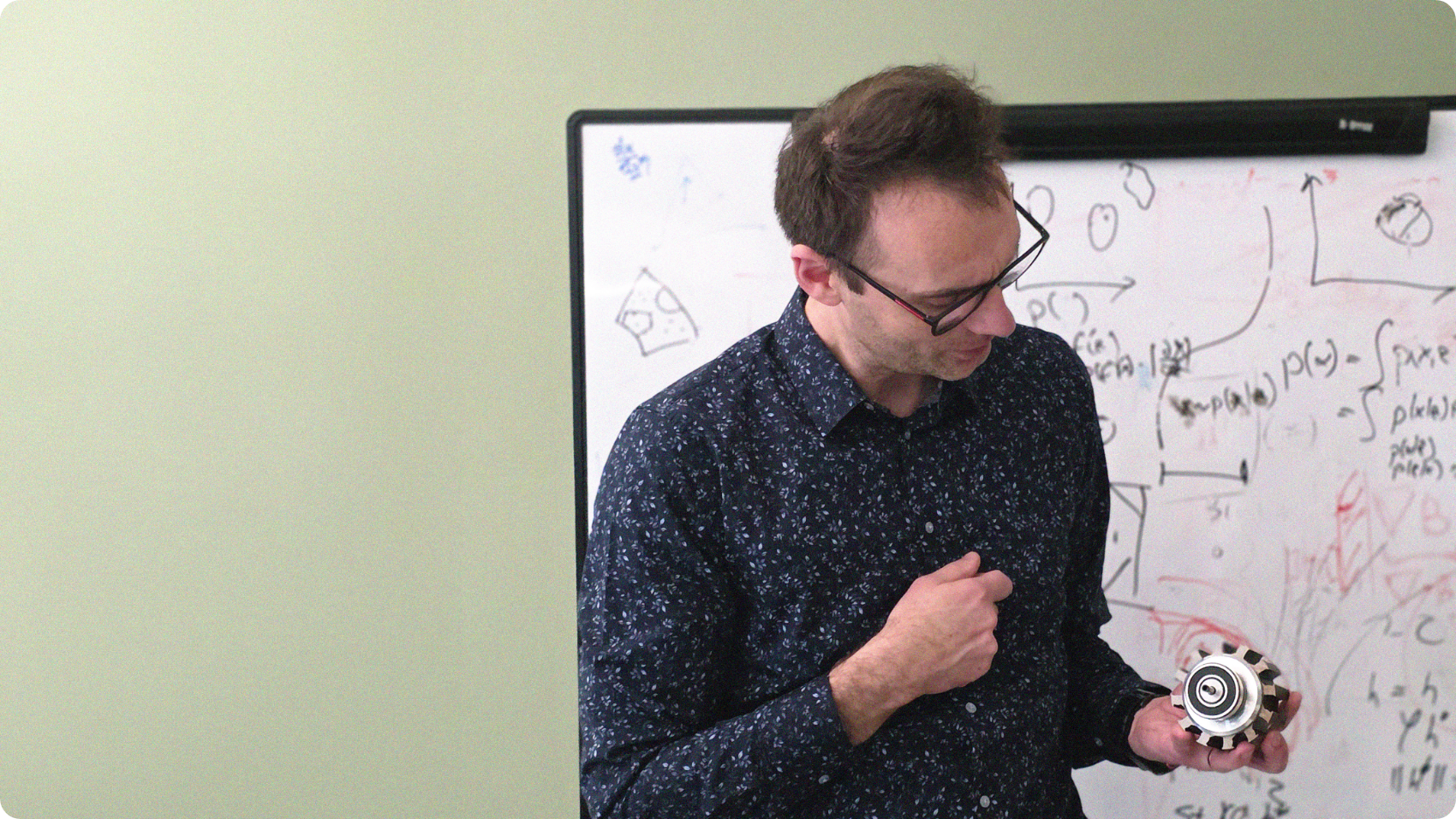 Dr. Jaroslaw Rzepecki explaining while holding a motor
