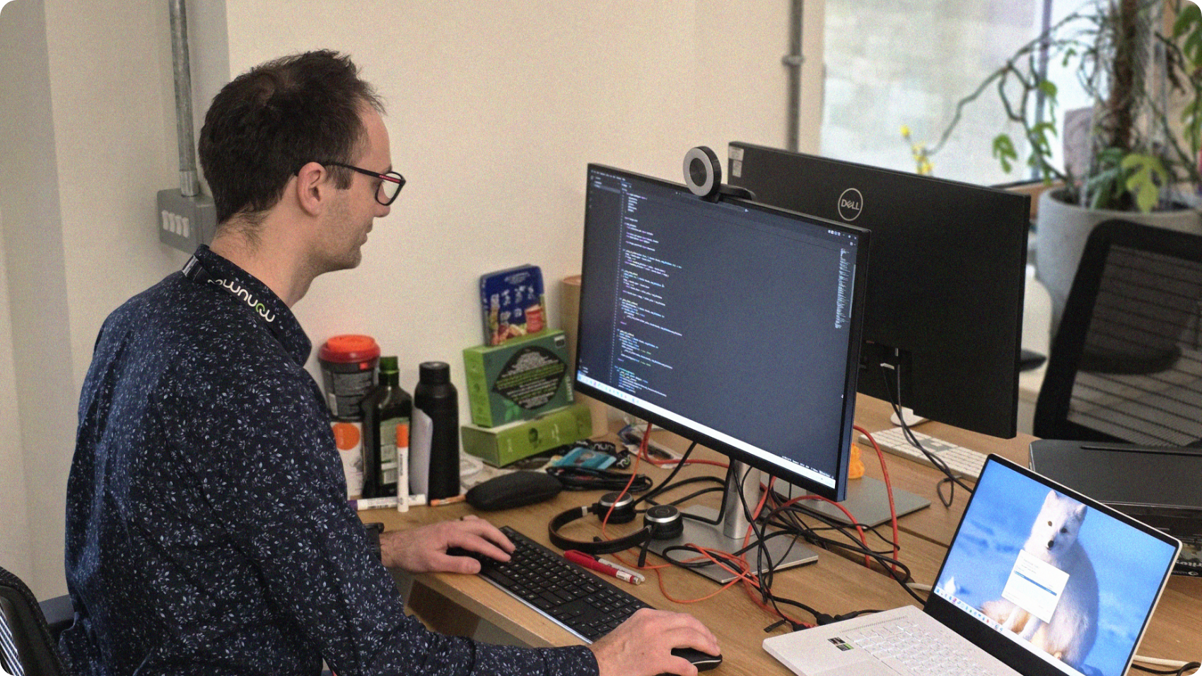 Dr. Jaroslaw Rzepecki sitting at a PC writing code