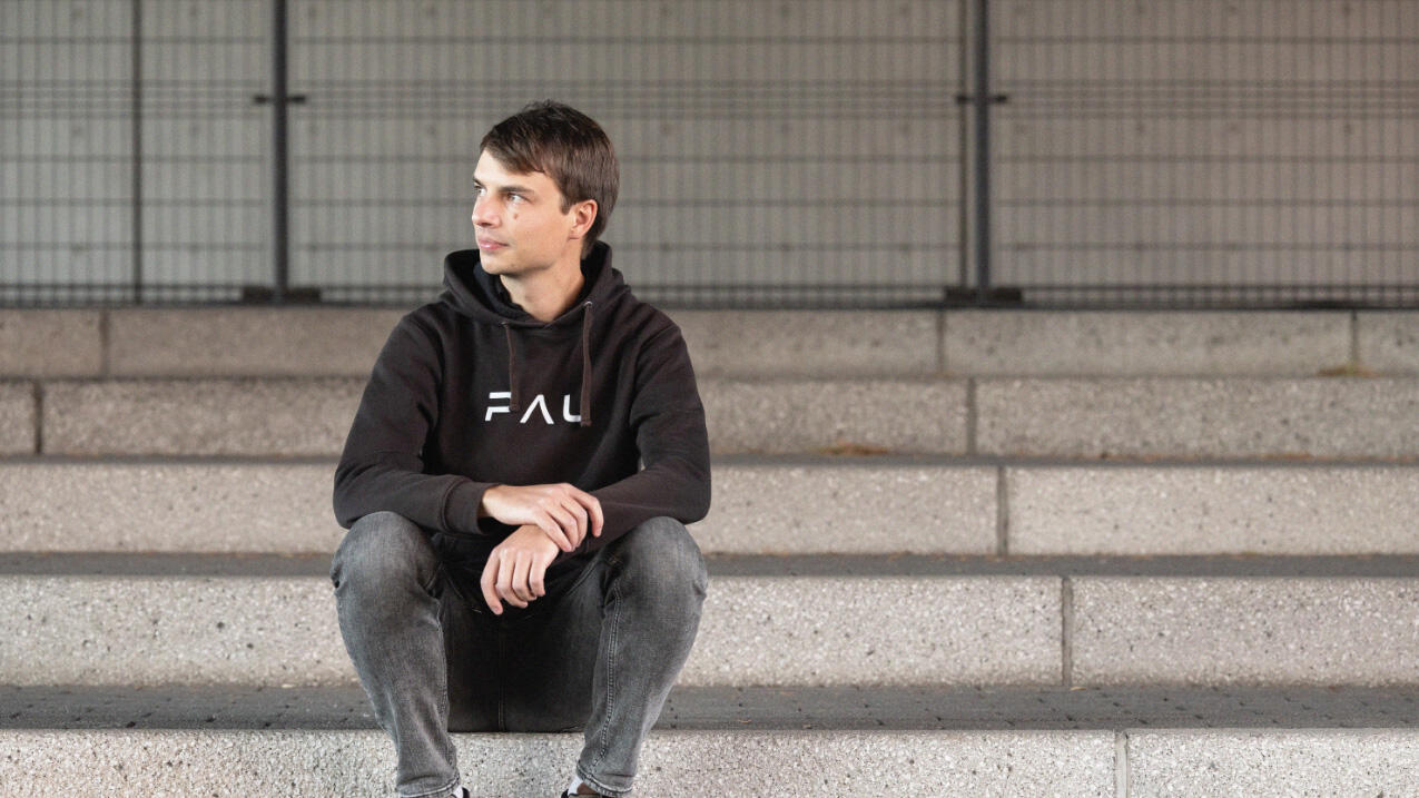 Thomas sitting on the stairs, looking to the left