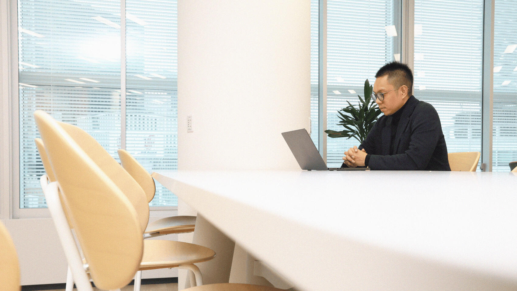 Erwin operating his PC while seated at his desk